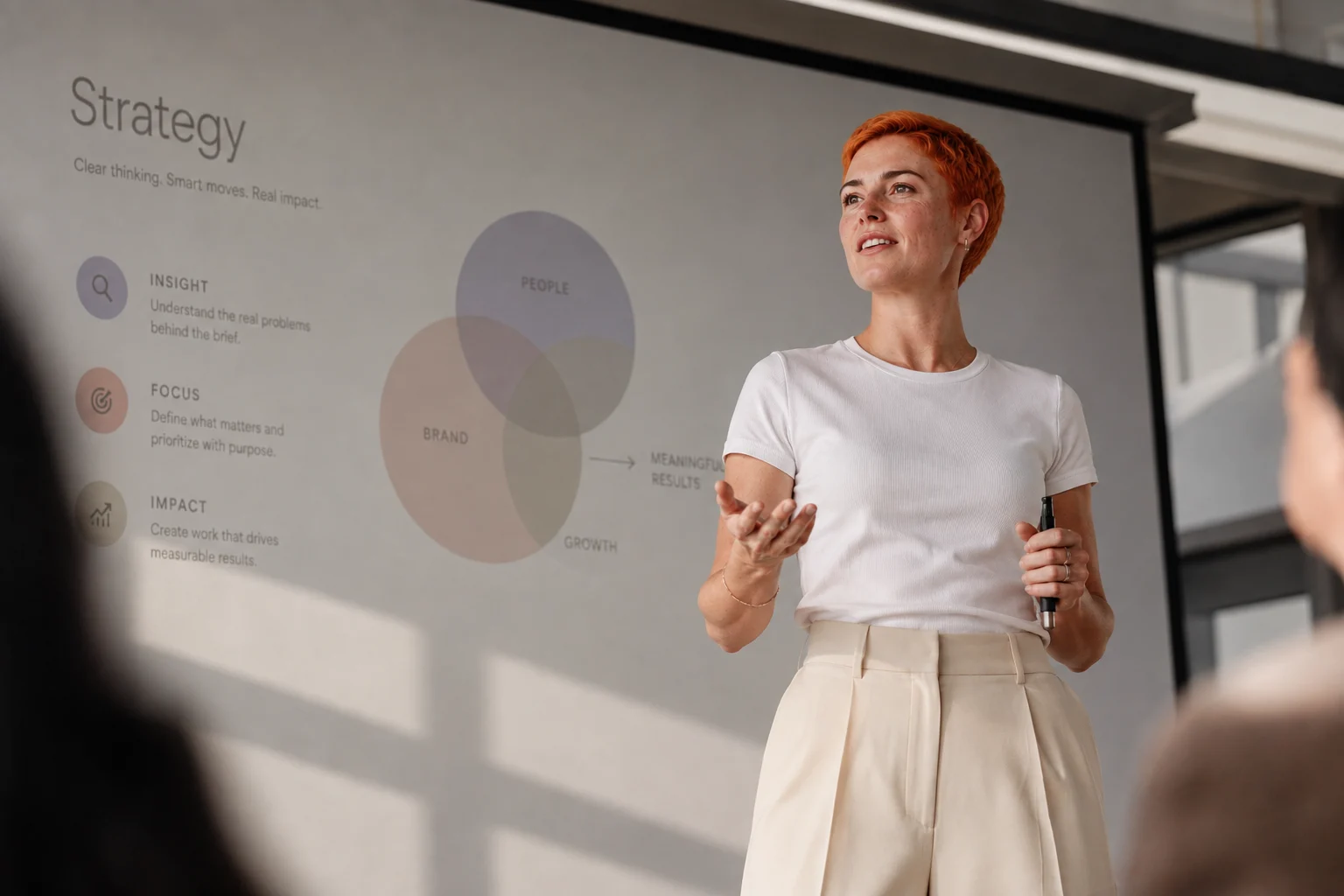 Presenter speaking in front of a strategy slide